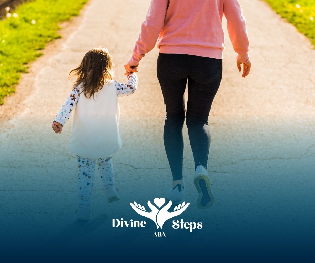 Mother and child walking on a path holding hands; child is in front of the mother.
