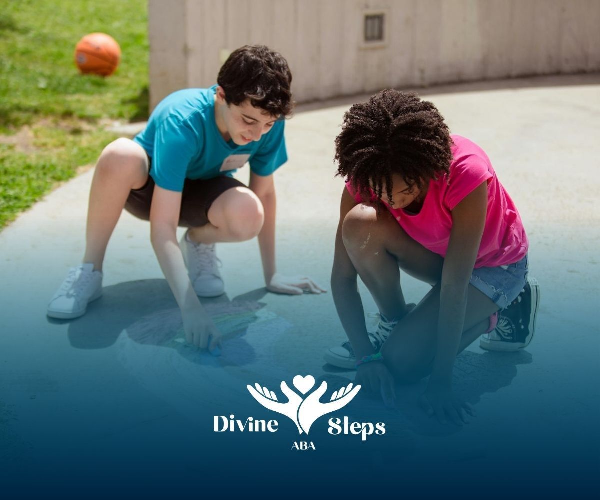 Two autistic kids drawing rainbow with chalk on pavement outside during ABA therapy in Virginia.