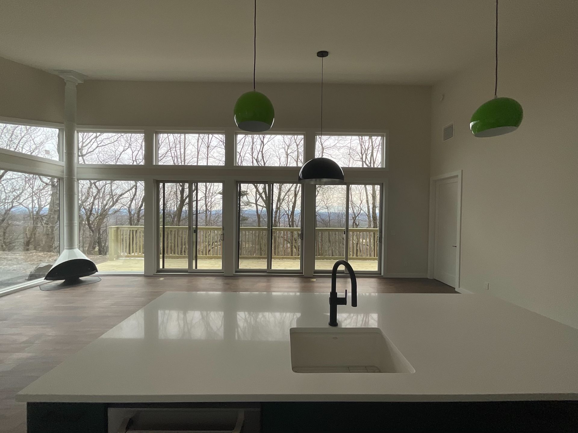 A kitchen with a sink and a lot of windows