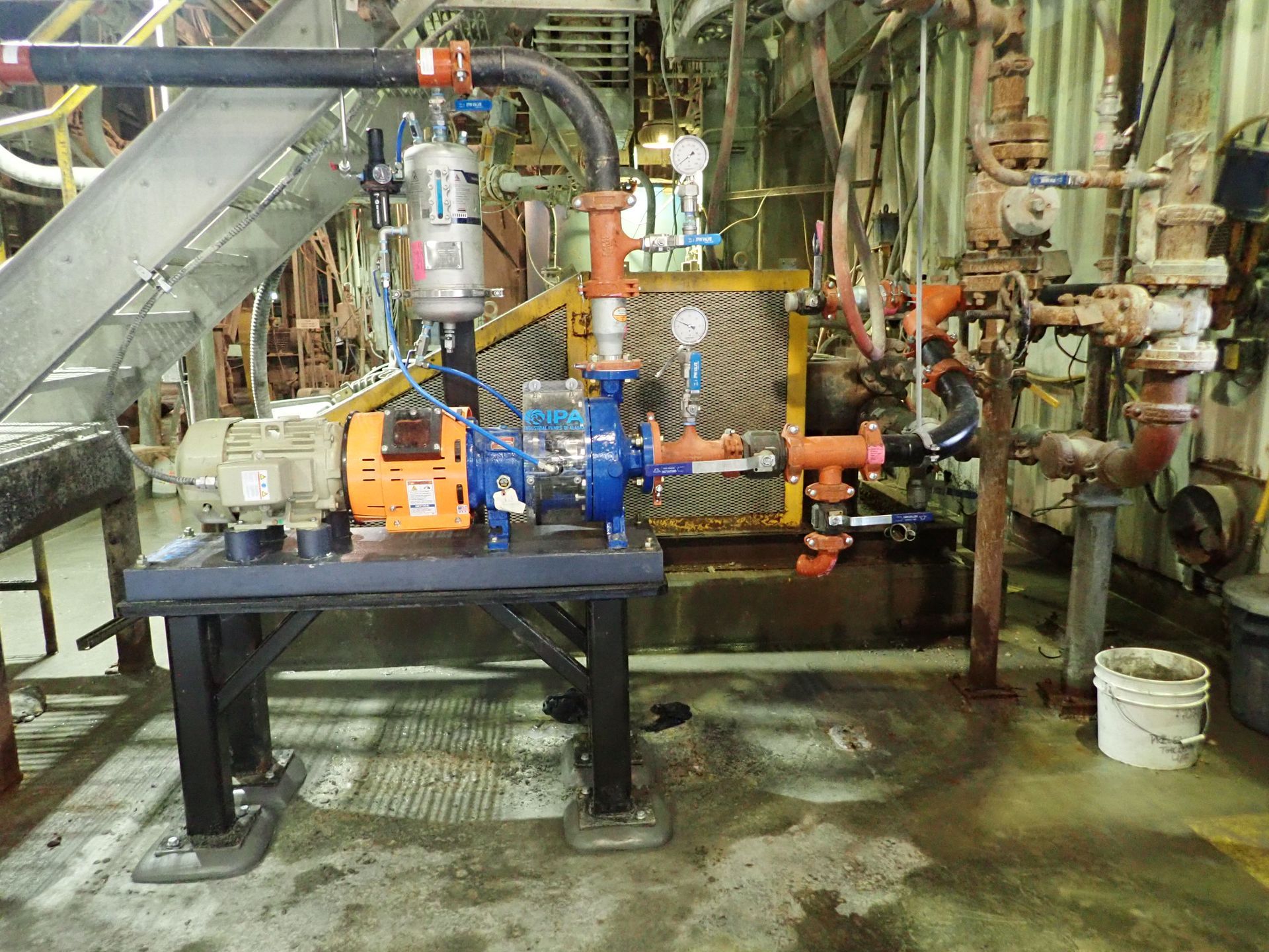 A machine is sitting on a table in a room with pipes