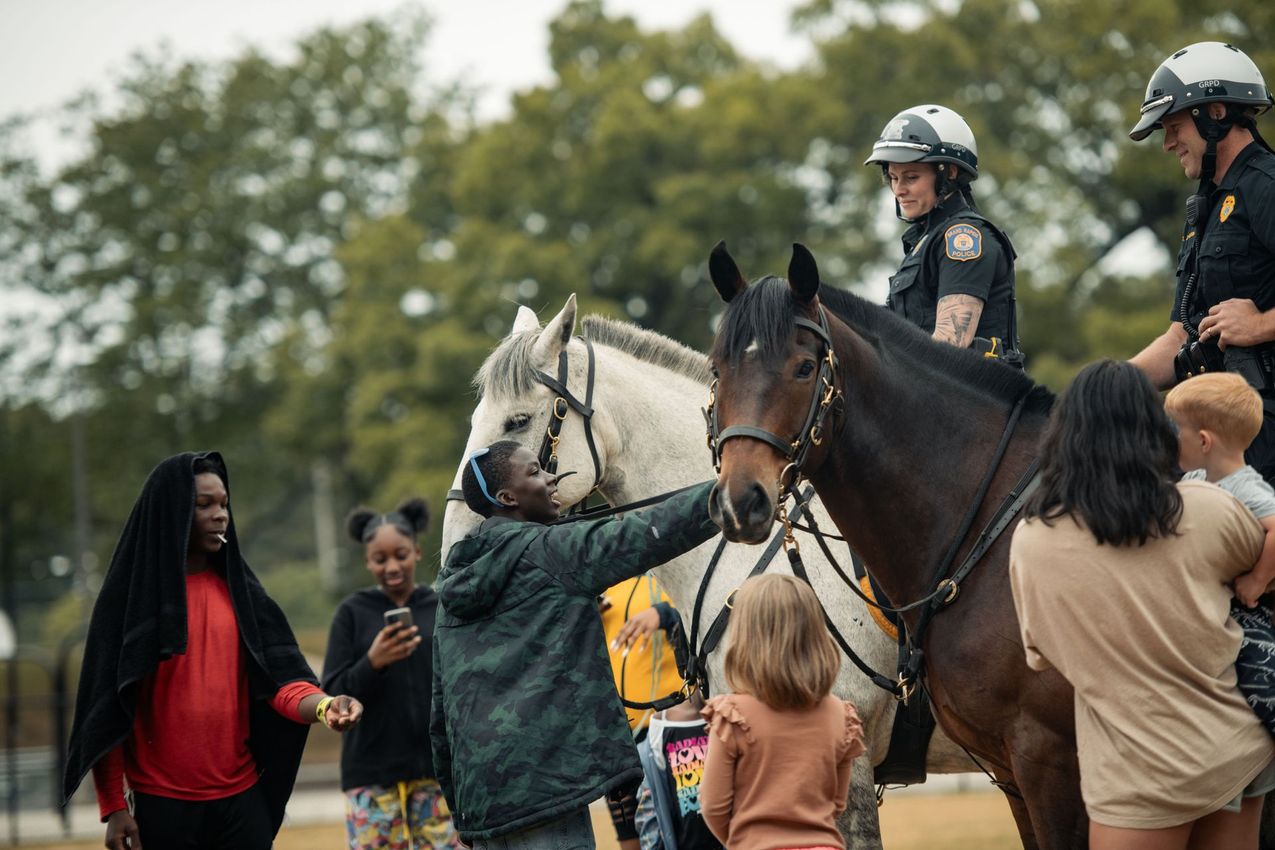 Hockey player in blue uniform and helmet, holding a hockey stick, with blue light effects.