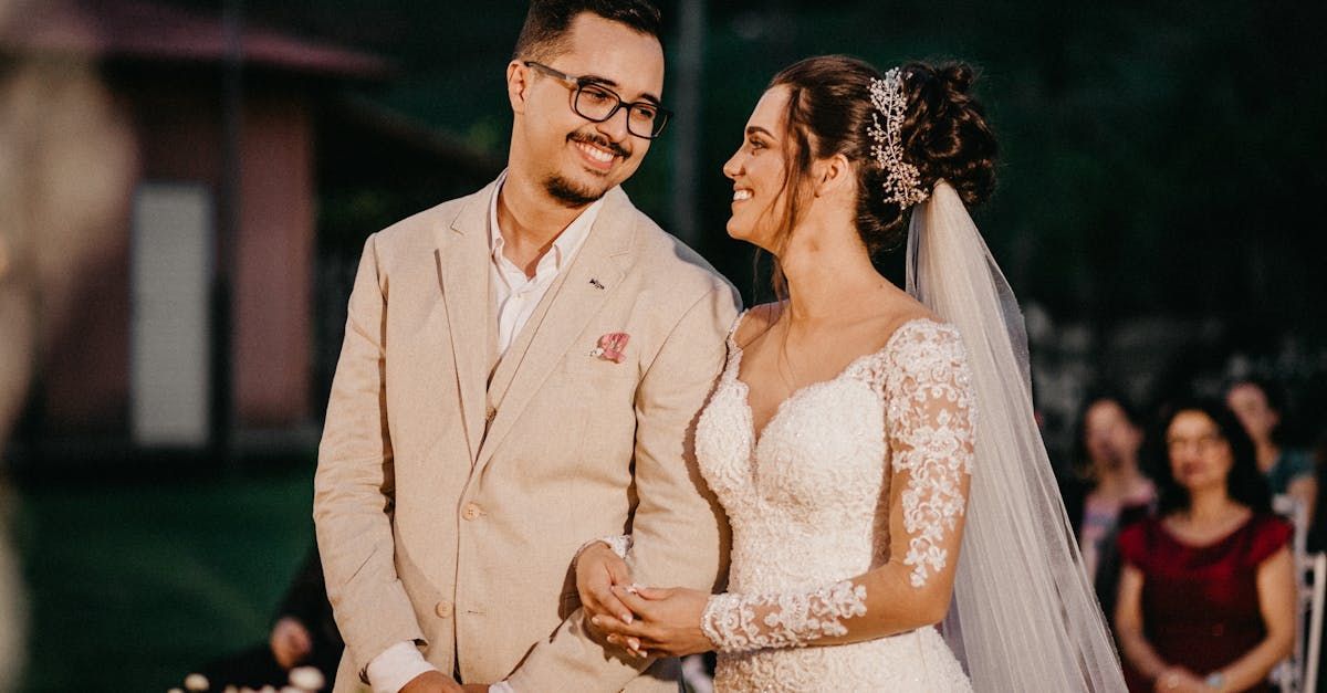 A bride and groom are looking at each other during their wedding ceremony.