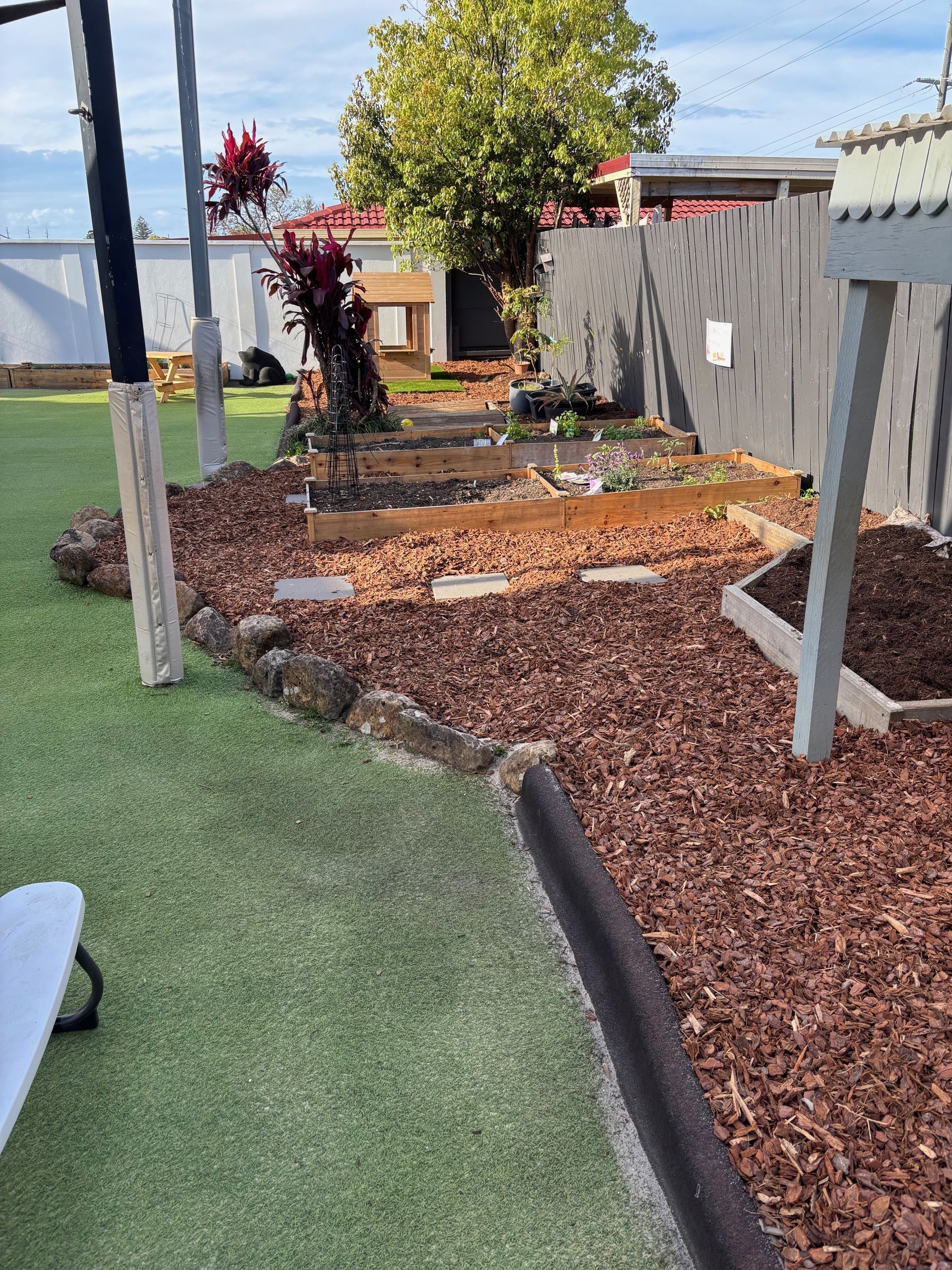 Gardener trimming a manicured hedge in a lush garden — Rohan's Maintenance in Robina, QLD