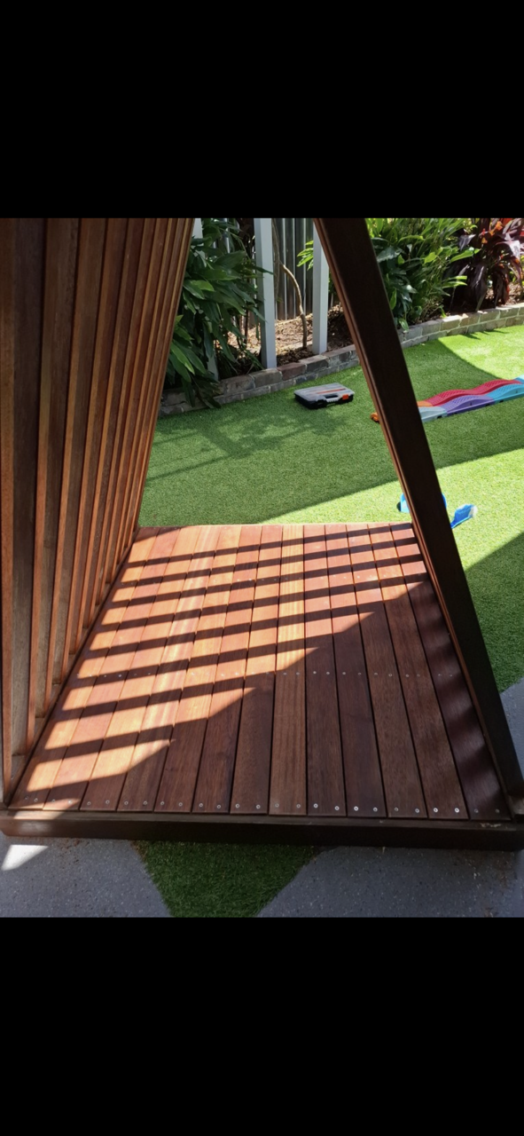 Wooden triangular structure with a slatted floor, open to a grassy yard — Rohan's Maintenance in Robina, QLD