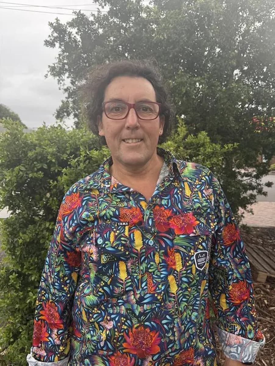 Person Wearing a Colorful Floral Shirt and Glasses, Smiling Outdoors in Front of Trees — Catios By Paulie in Blackbutt, NSW