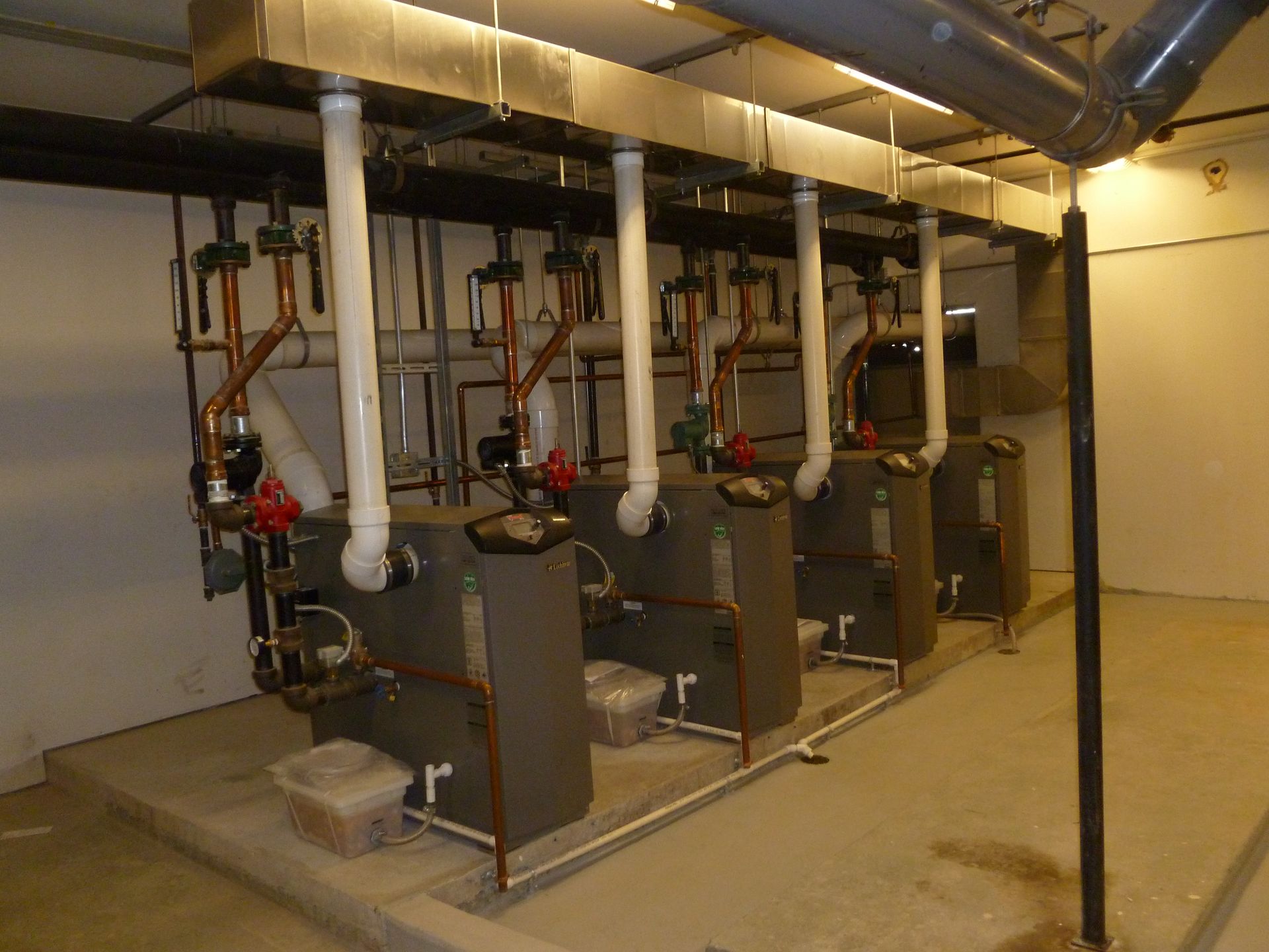 A row of boilers are lined up in a room