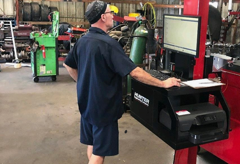 Our expert technician performing wheel alignment service in our garage in Bloomingdale, GA | Elton's Auto