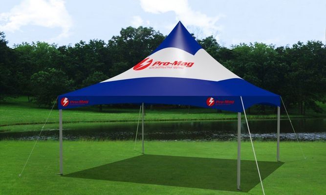 Blue and white tent with pro-mag logo set up on green grass
