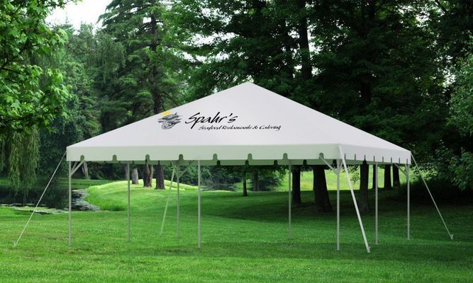 White tent set up on a green lawn