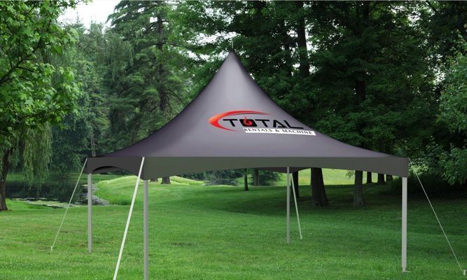 Black tent with total logo set up in a park