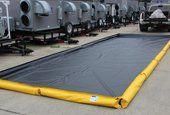 Black containment berm with yellow sidewalls
