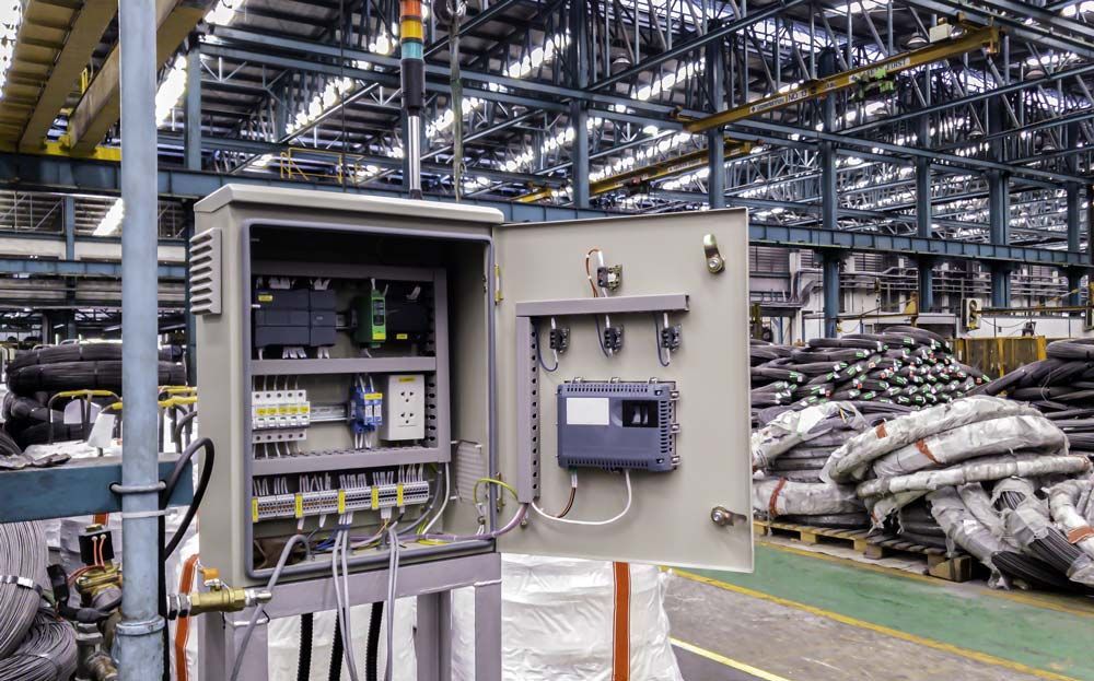 A security camera is sitting on top of a pole in front of a building.