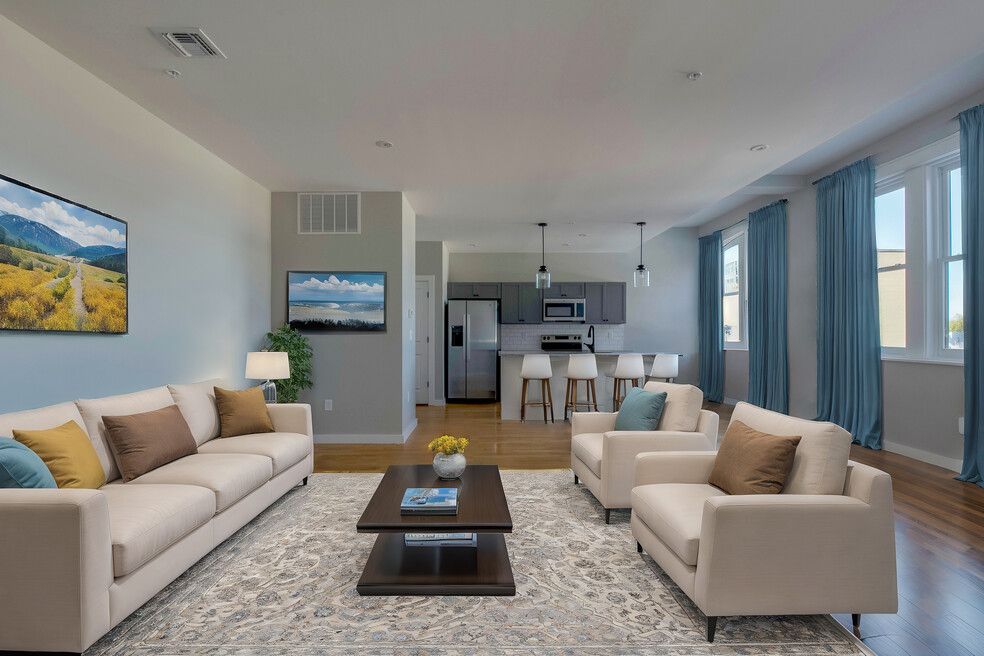 A living room with two couches , two chairs , a coffee table and a television.