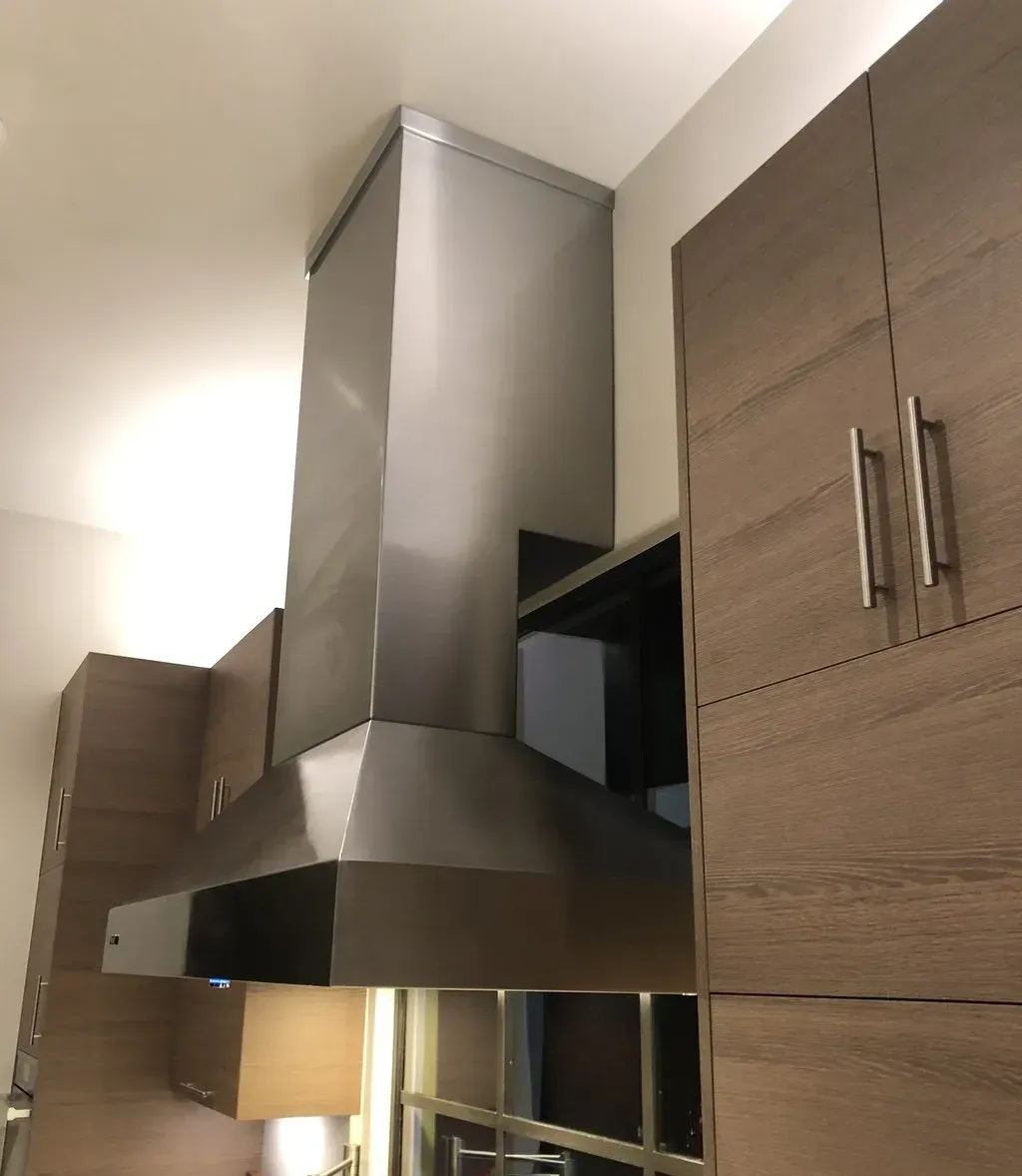 A kitchen with stainless steel appliances and wooden cabinets