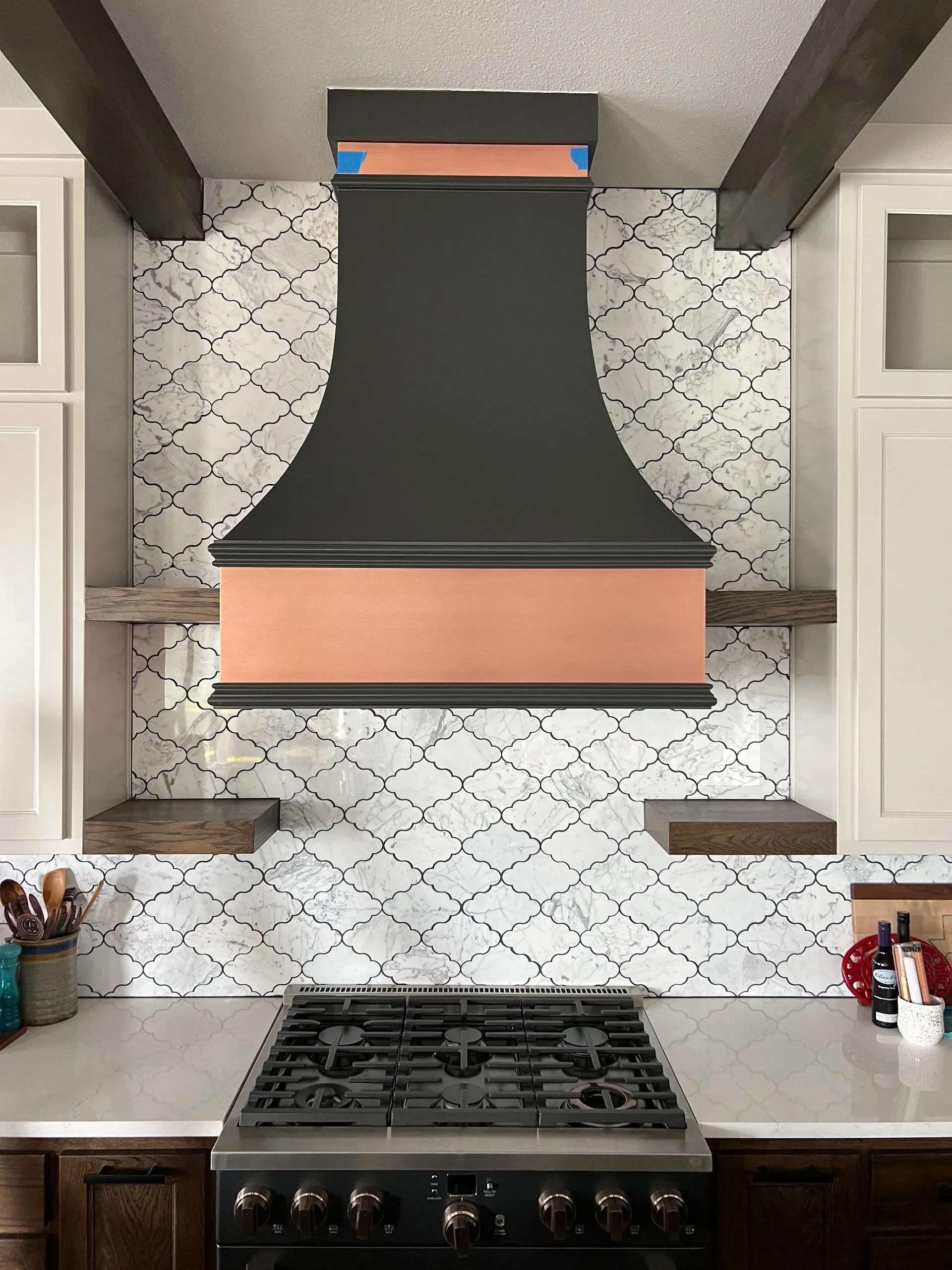 A kitchen with a copper hood above the stove