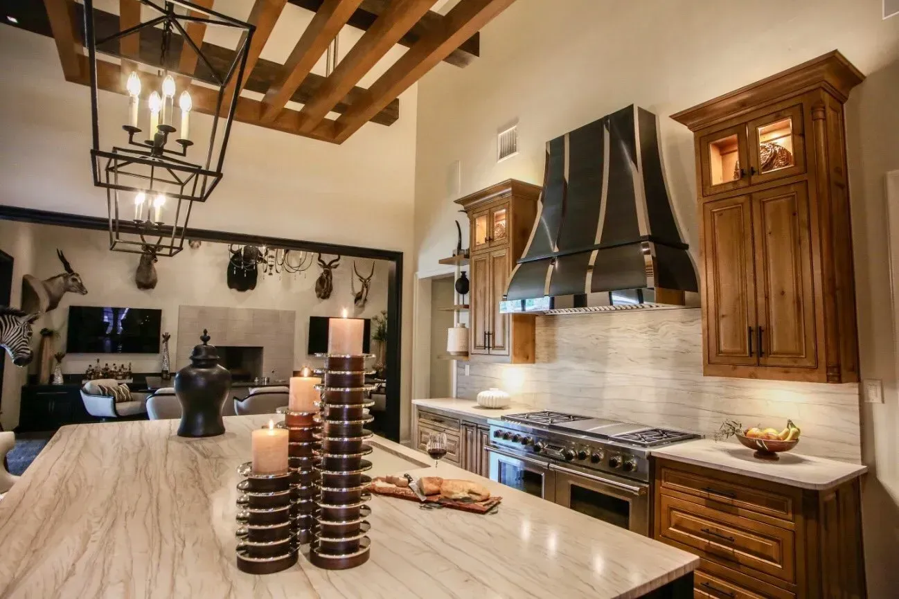 A kitchen with a large island and a stove top oven.