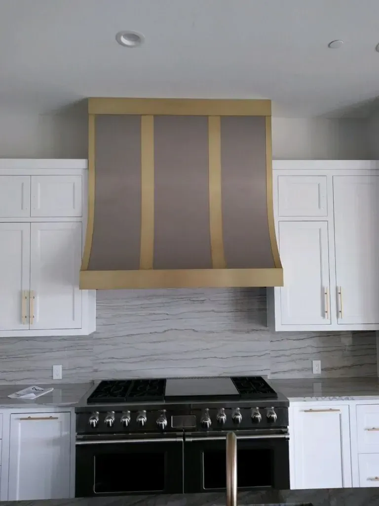 A kitchen with white cabinets and a black stove top oven