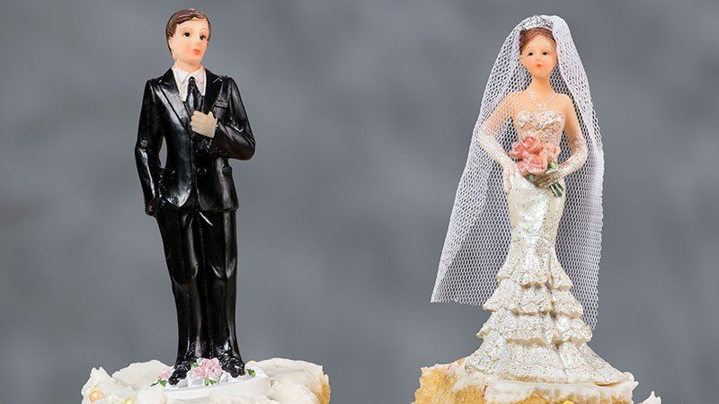 figures on top of a wedding cake