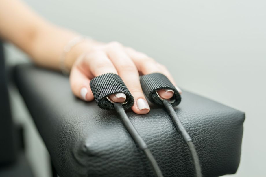 A close up of a person 's hand with a pair of wires attached to it.