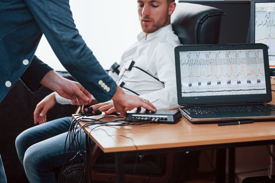 A man is sitting at a desk with a laptop on it.