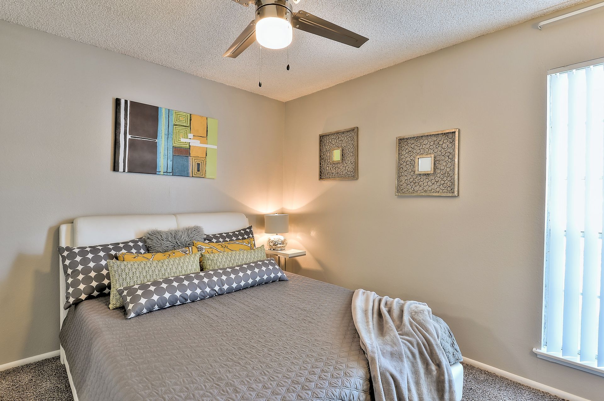 A bedroom with a bed , ceiling fan , and window The Park at Idlewild. 