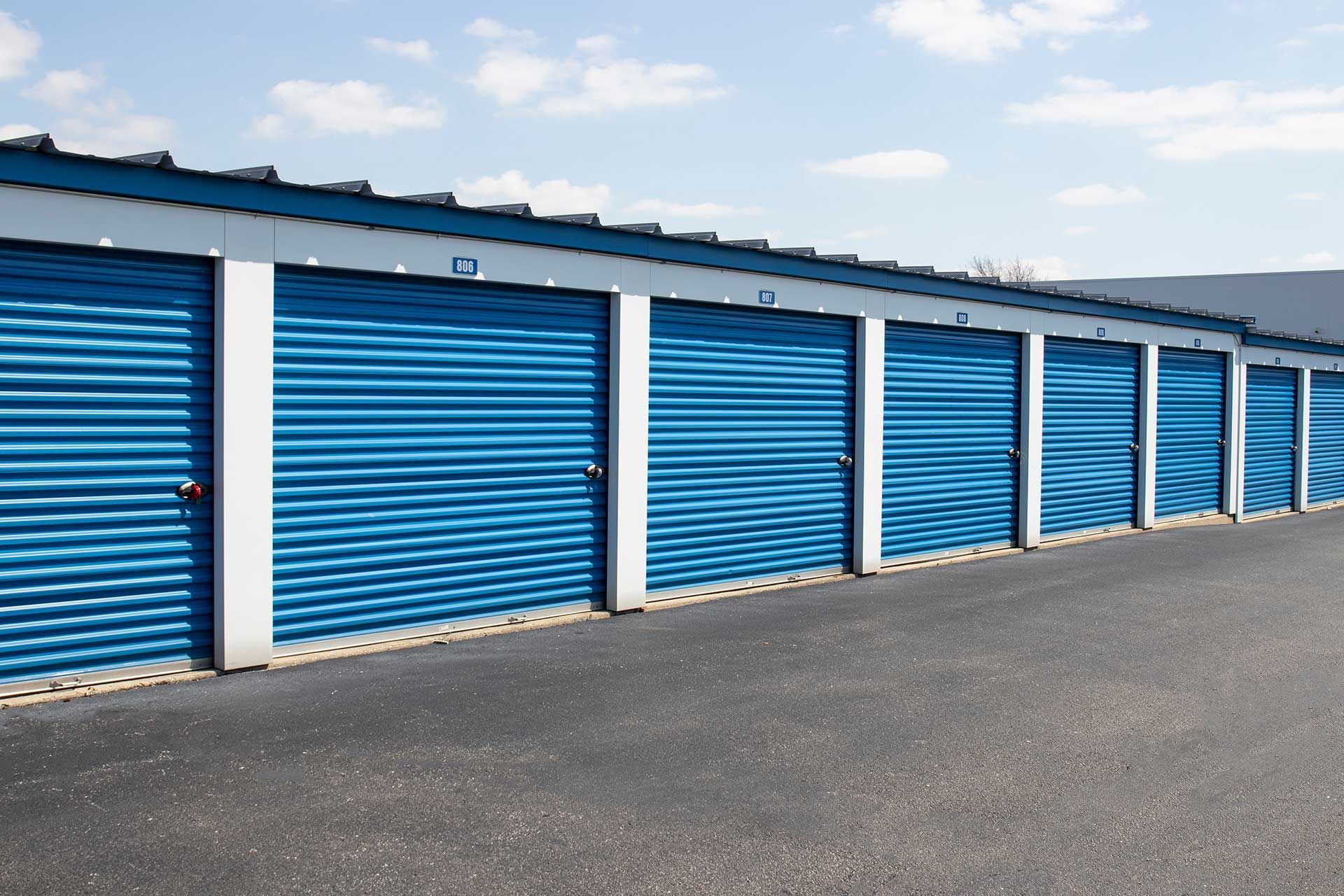 A row of blue garage doors with the number 13 on them