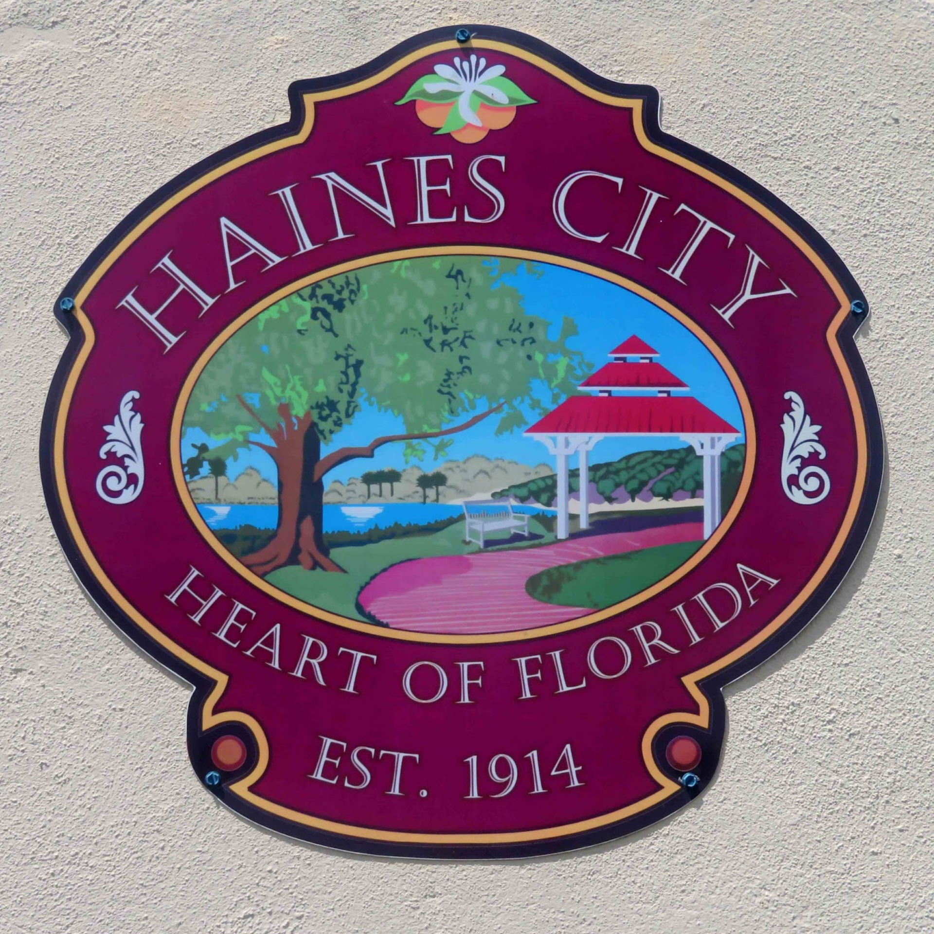 A maroon sign reading 