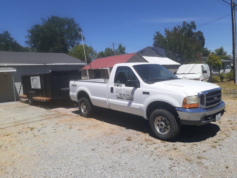 Kiwi's Junk Busters hauling truck on a residential junk removal job in Anderson CA