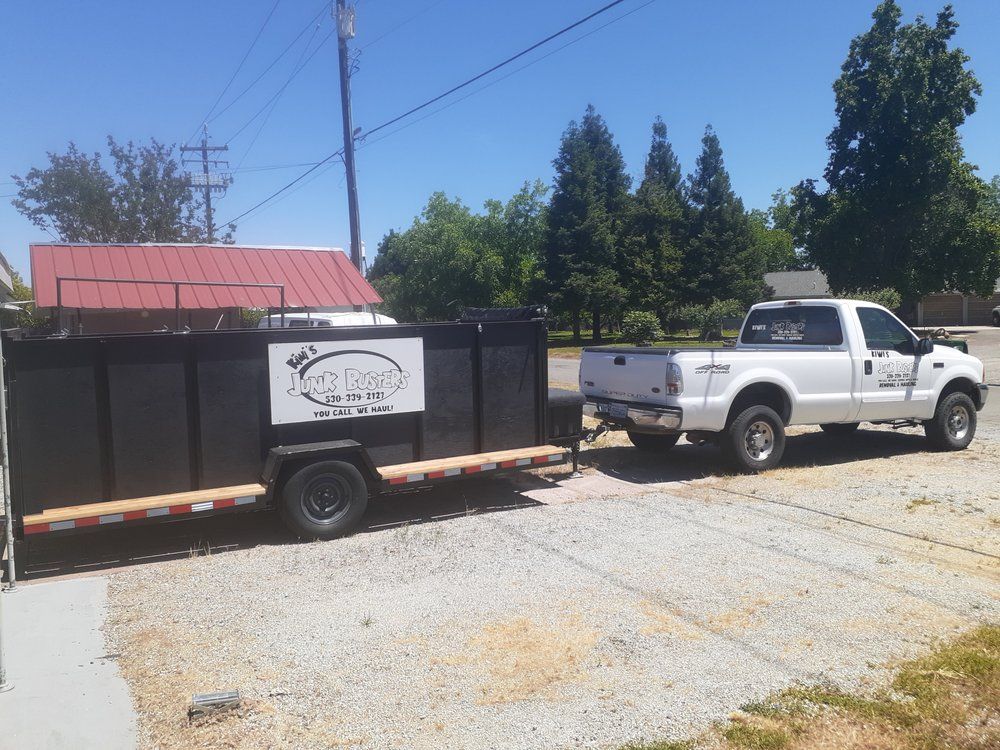 Kiwi's Junk Busters hauling truck on a residential junk removal job in Anderson CA