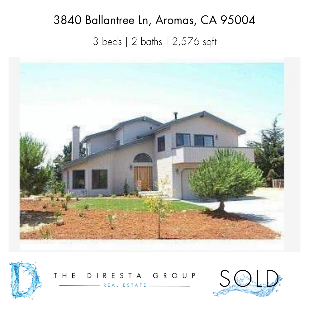 Modern white bathroom with a double vanity, bathtub, and towel warmer.