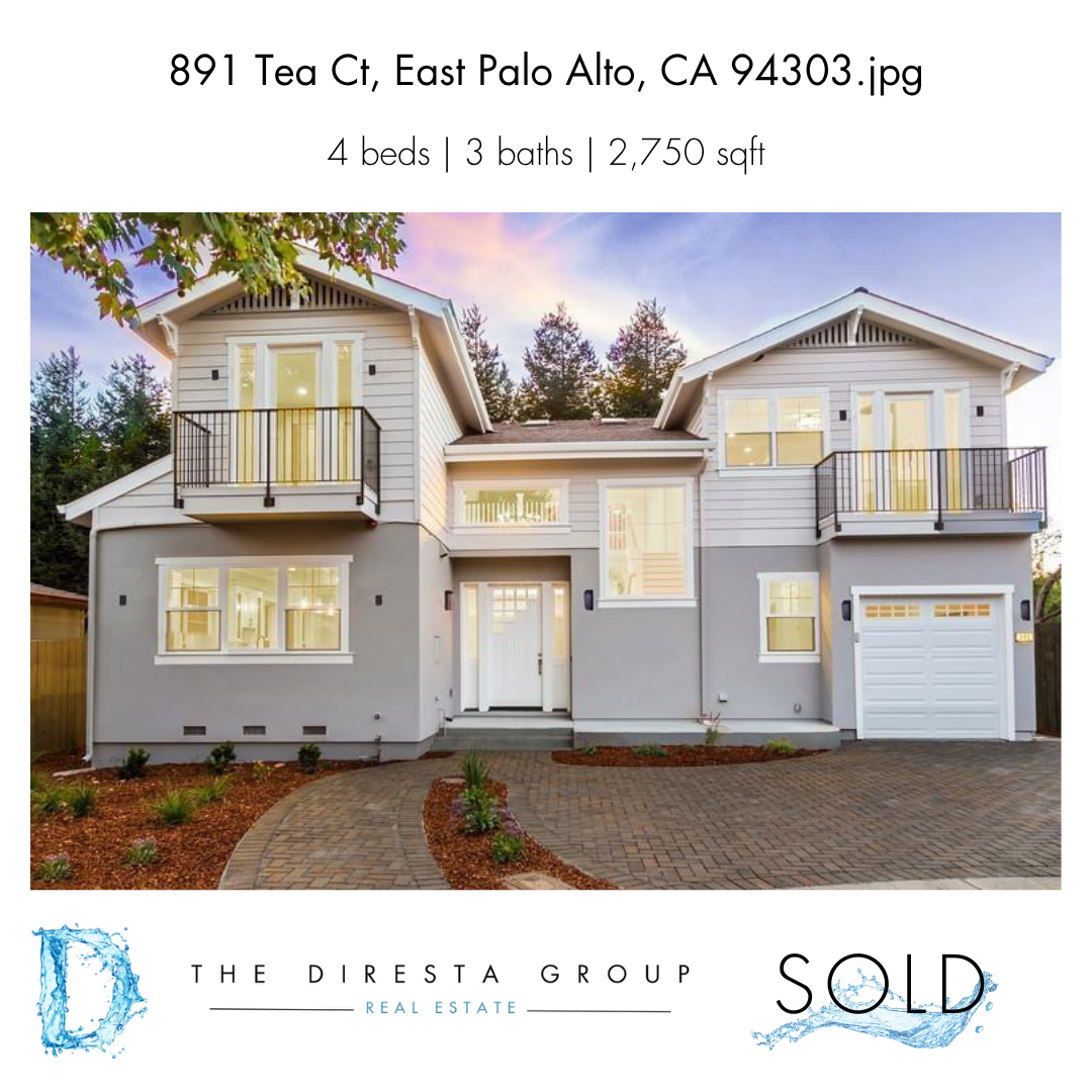 Bright white kitchen with island, stainless steel appliances, and light wood floors.