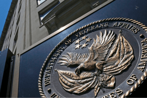 Soldier in camouflage with a German Shepherd dog overlooking a body of water. Sunny day.