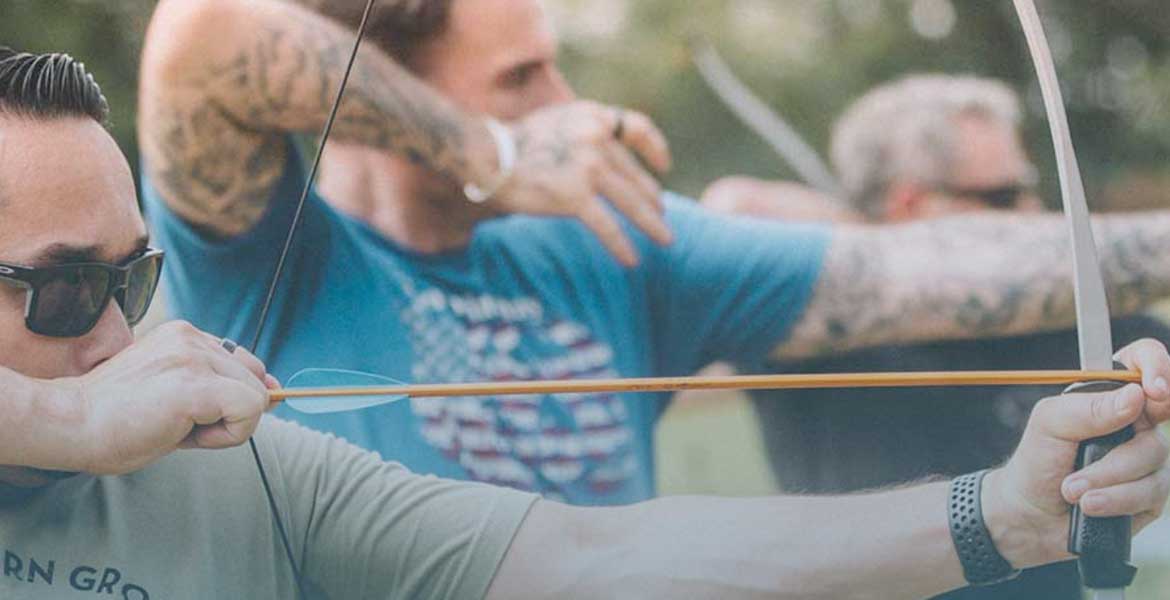 Soldier in camouflage with a German Shepherd dog overlooking a body of water. Sunny day.