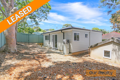 A balcony with a couch and a table with a view of a city.
