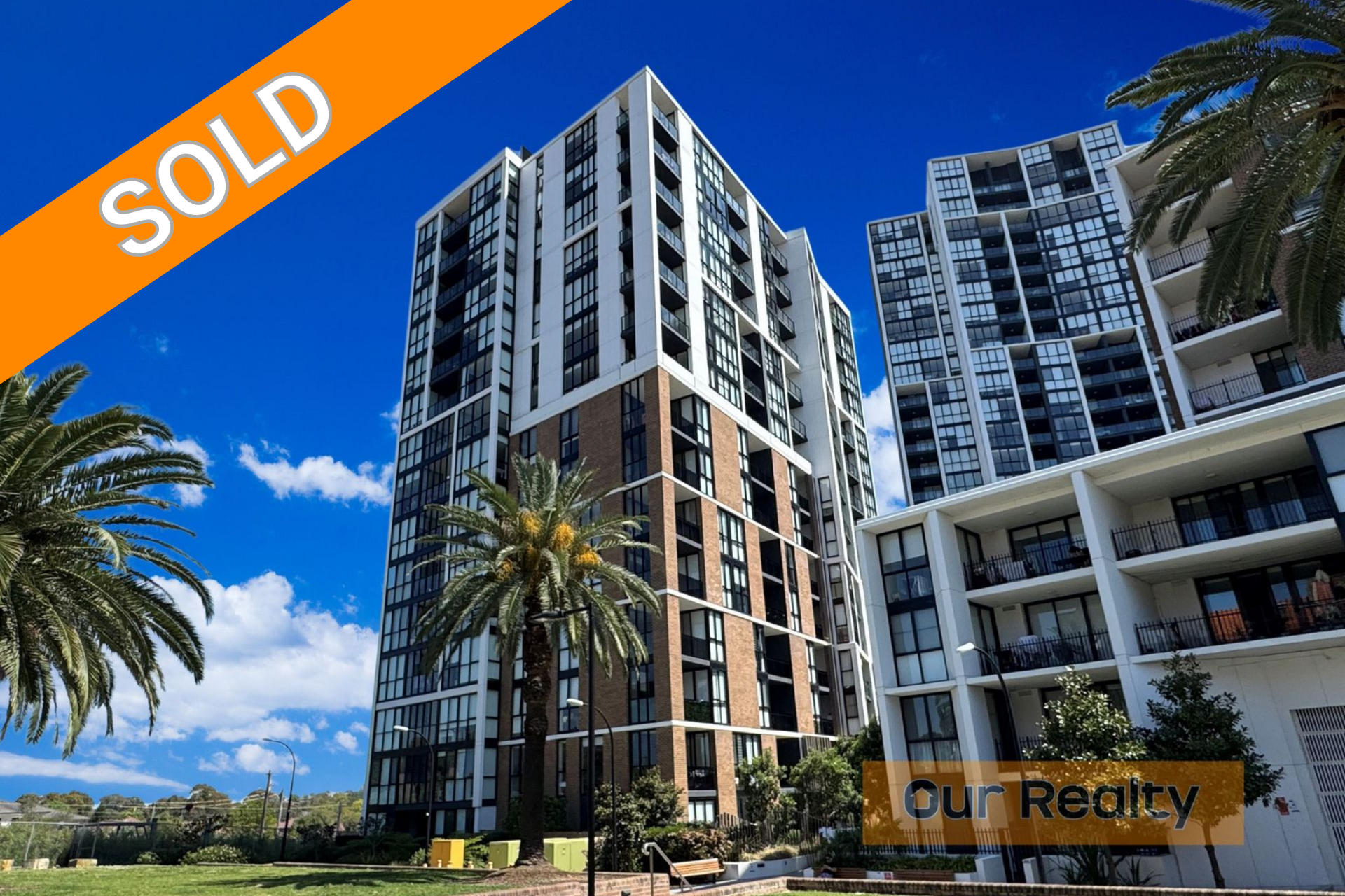 A balcony with a couch and a table with a view of a city.