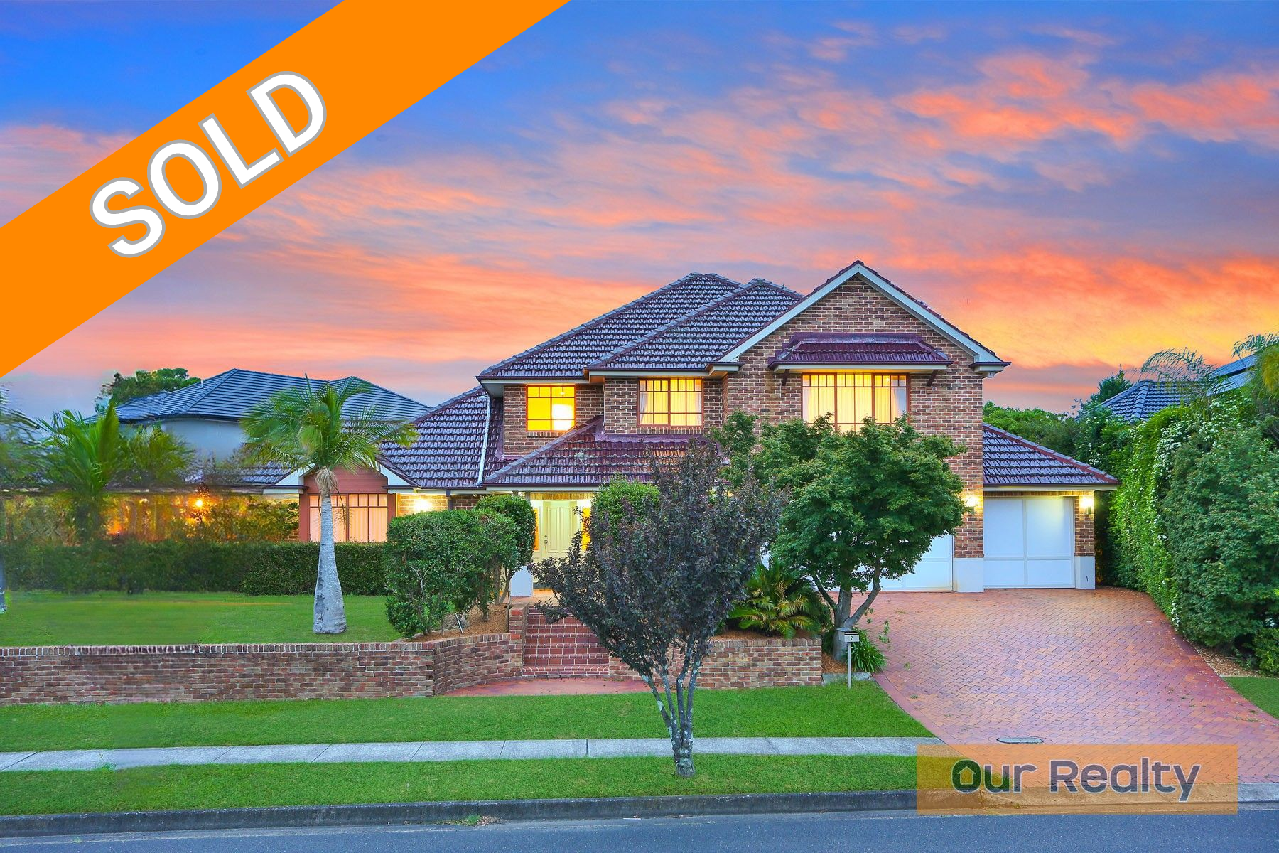 A balcony with a couch and a table with a view of a city.