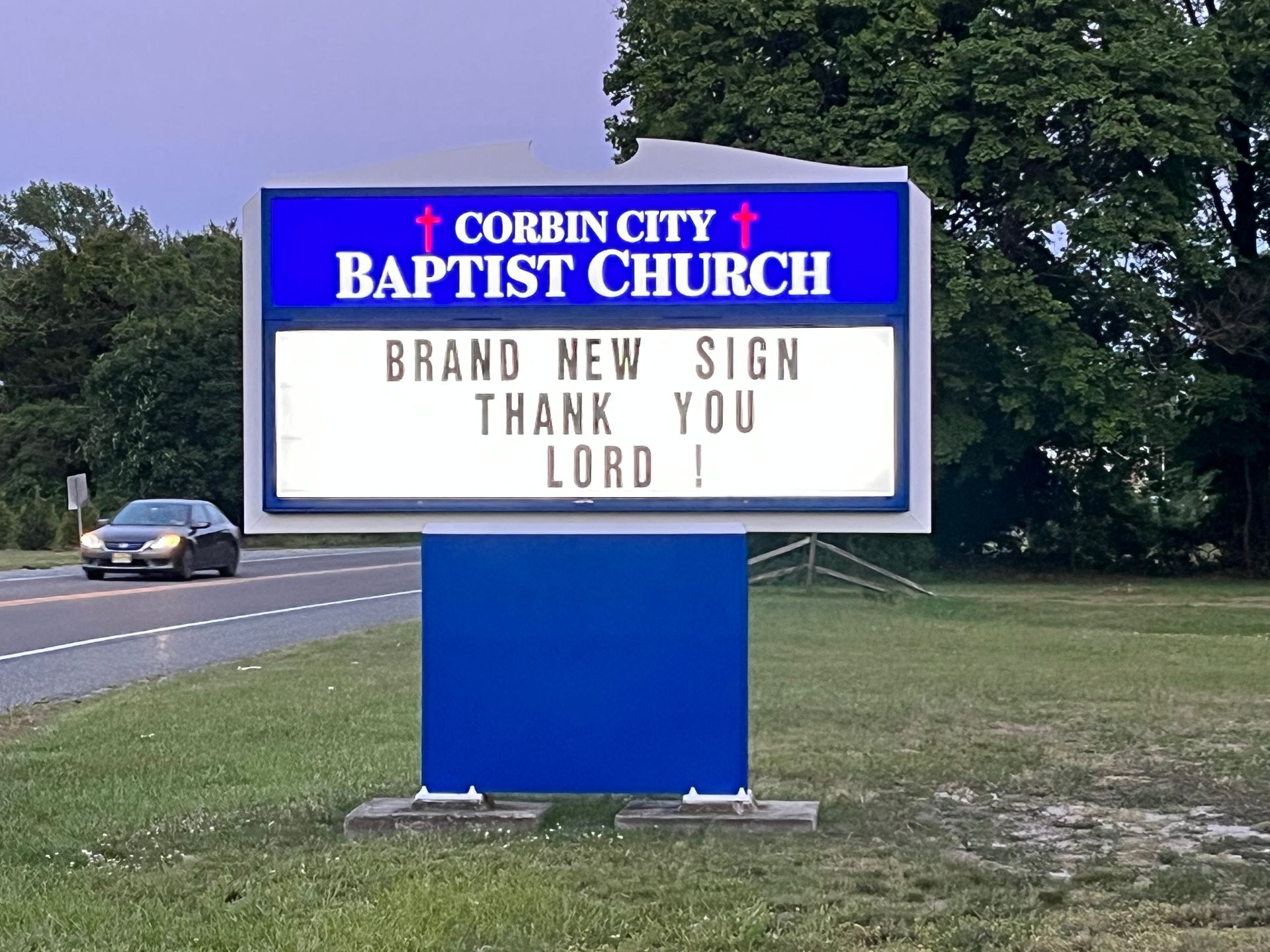 Corbin City Baptist Church sign with a blue border. The sign reads