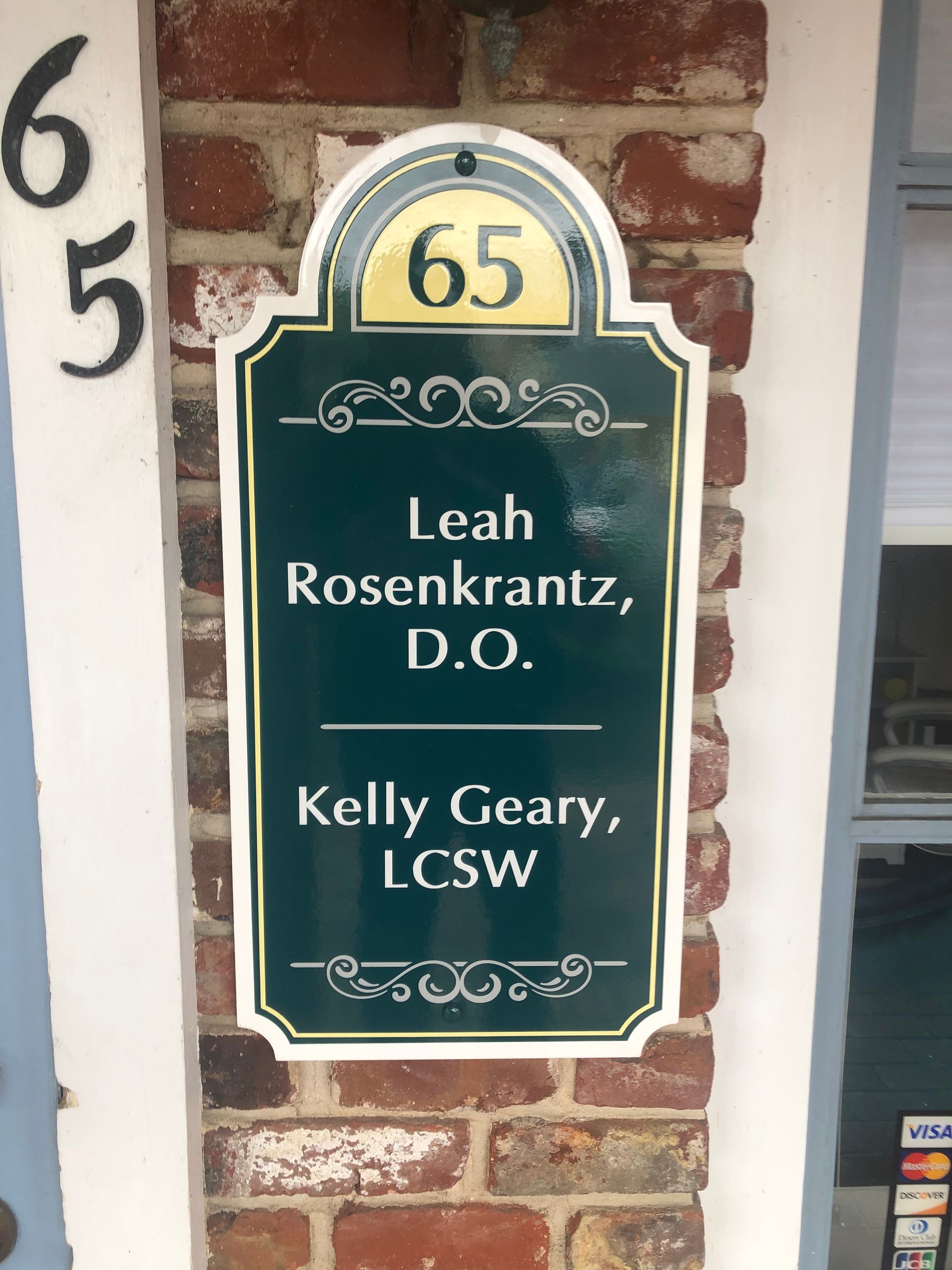 Sign on brick building: address 65, names Leah Rosenkrantz, D.O. and Kelly Geary, LCSW.