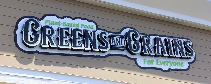 Blue and silver Bacharach Institute for Rehabilitation sign with directional arrows.