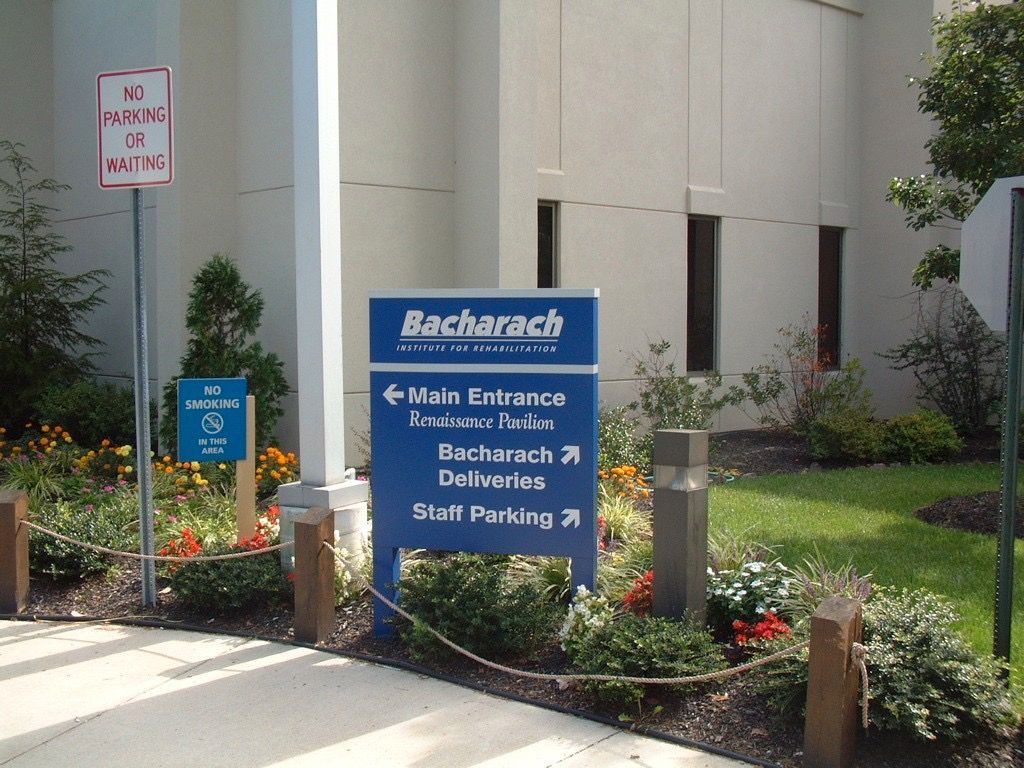 Sign for Bacharach, a rehabilitation hospital, indicating main entrance, deliveries, and staff parking.