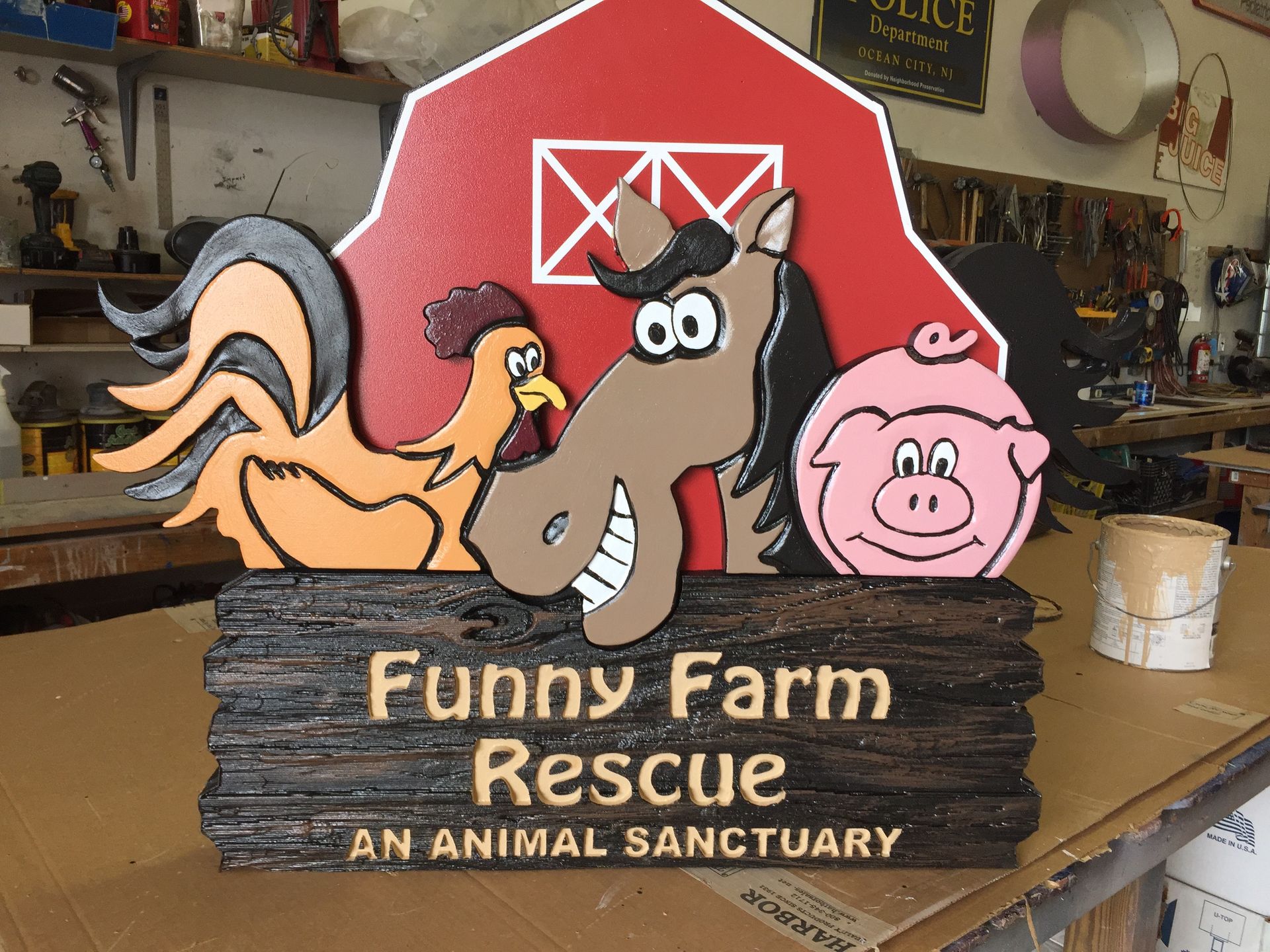 Sign with farm animals and text: 