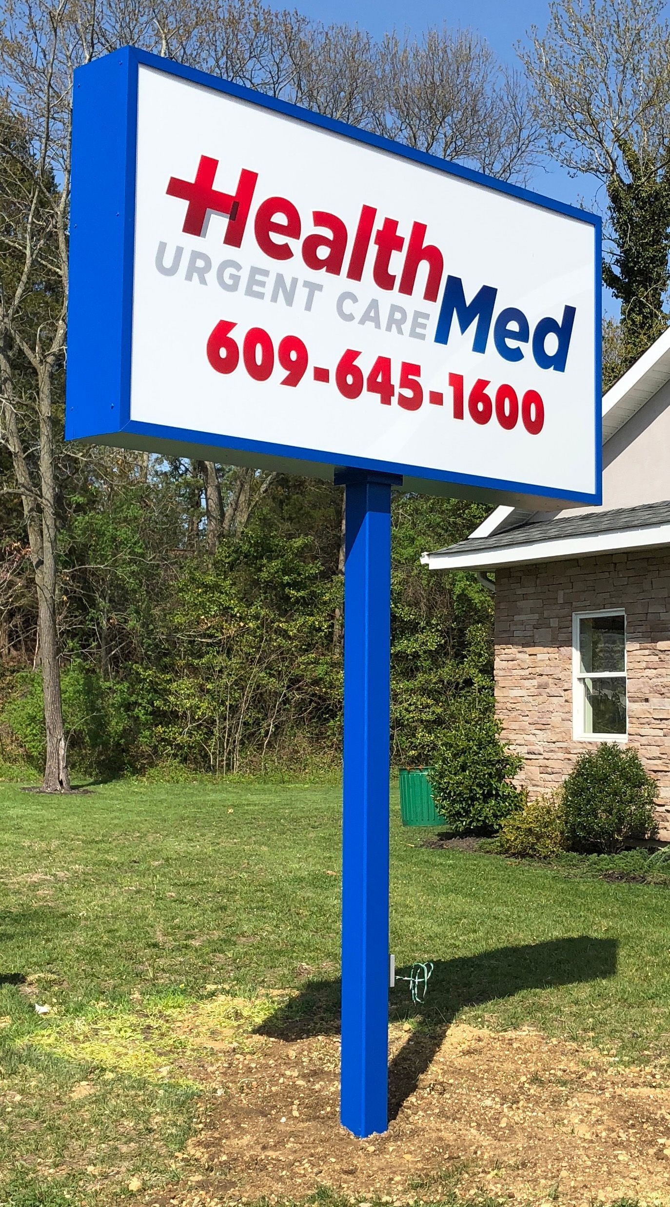 Blue and white HealthMed Urgent Care sign with phone number 609-645-1600.