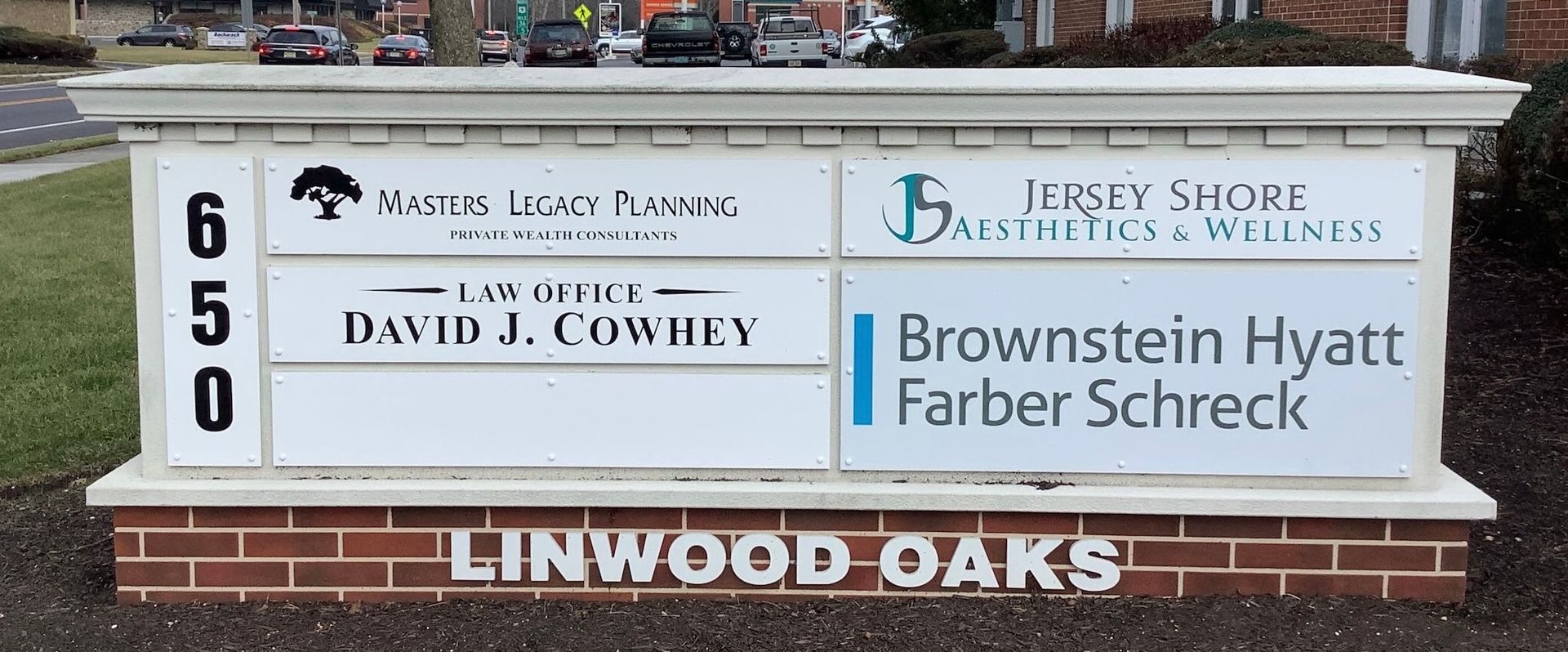 Sign for an office building with tenant names and the address 650.