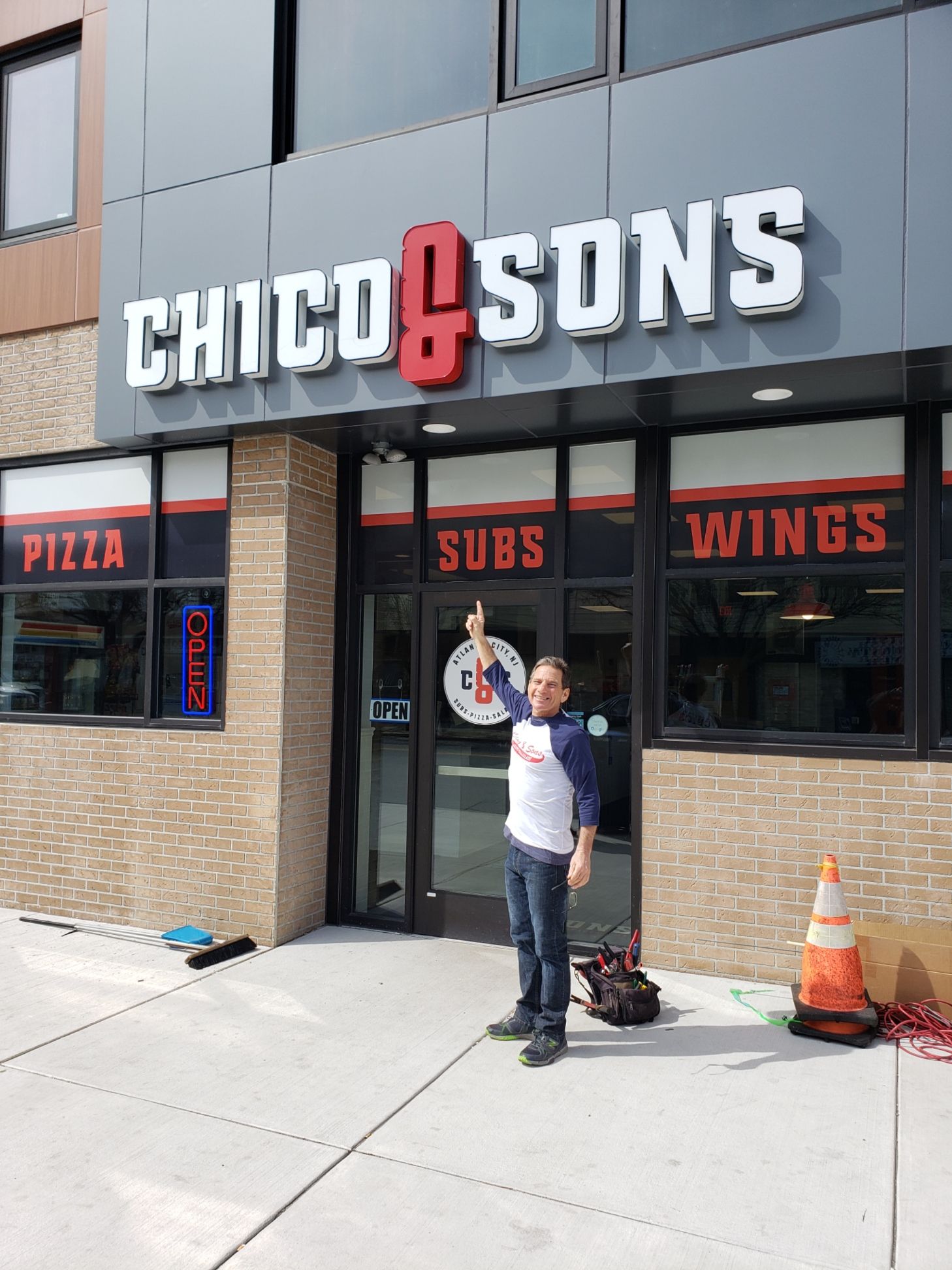 Pepsi sign with the brand's logo: red and blue globe, white background, blue base, outdoors.