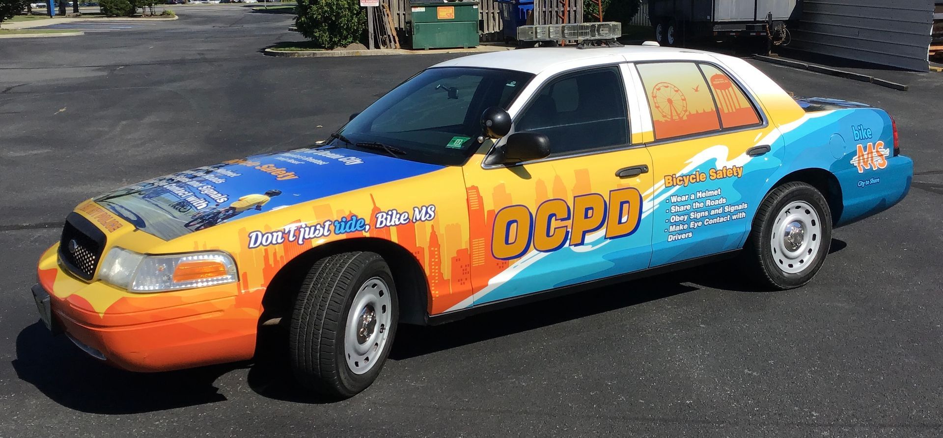 Sign for Katz JCC with green and white elements, and logos for 