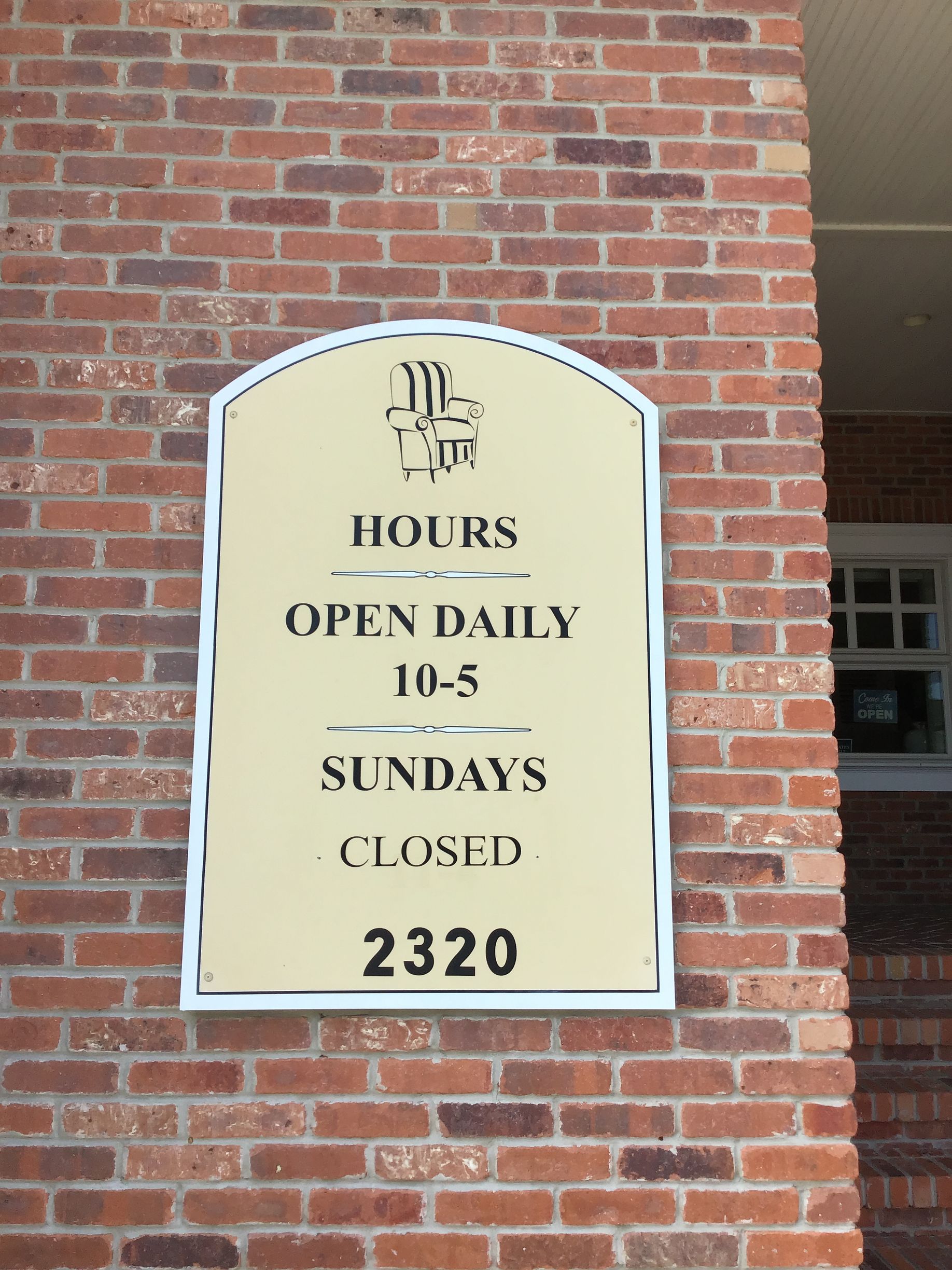 Sign on a brick wall: 