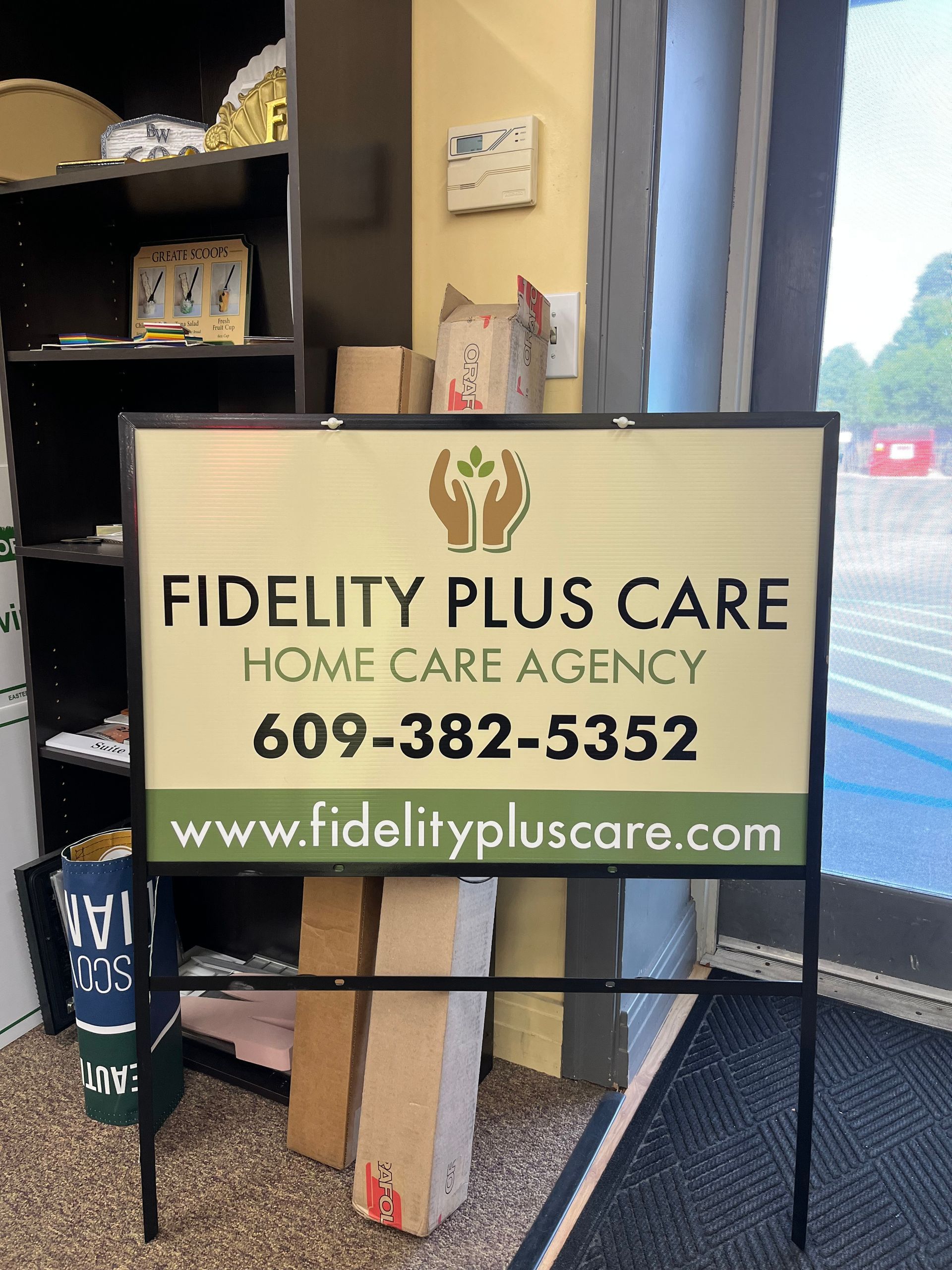 Sign for Fidelity Plus Care Home Care Agency, with logo, phone number, and website.
