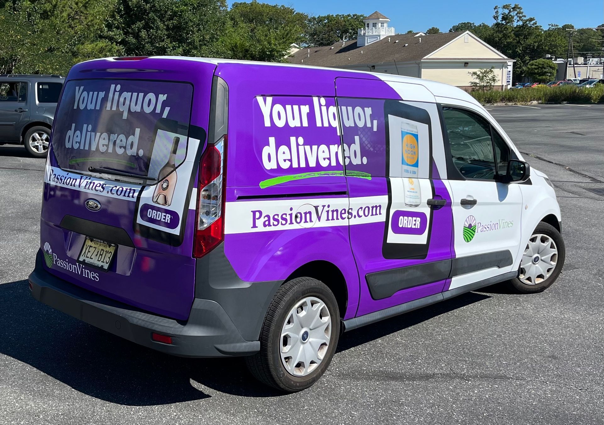 Sign for Sails Restaurant/Bar, with overlapping sail graphic, black background, silver lettering on gray stone base.