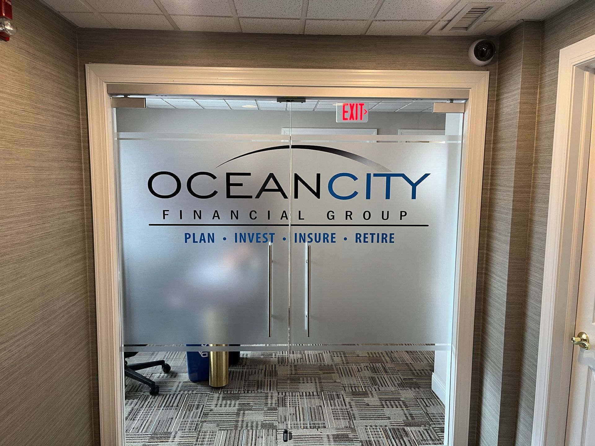 Ocean City Financial Group office entrance with frosted glass doors and logo.