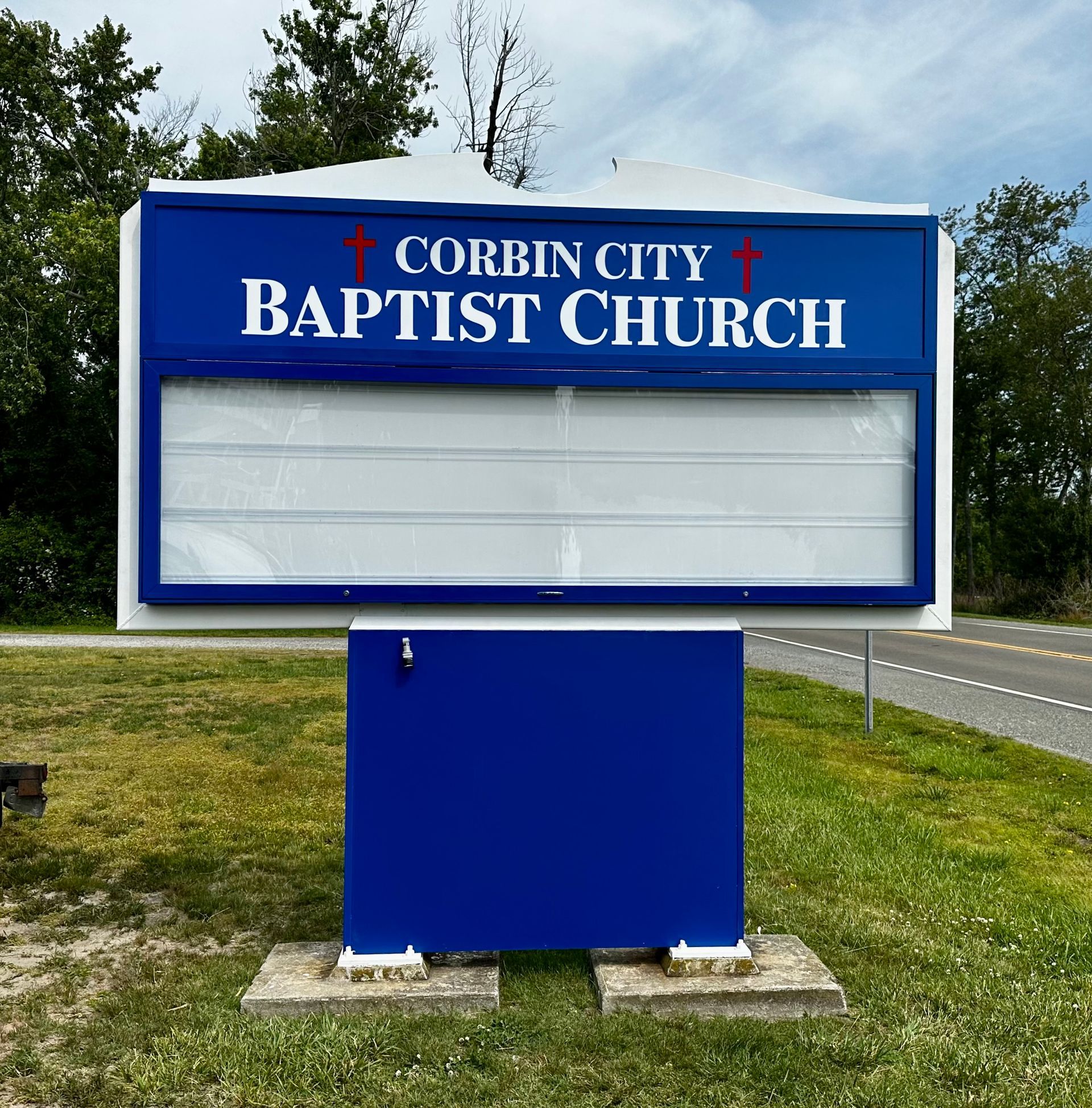 Sign for Virtua Health at Cornerstone, brown and beige with logo, near building and cars.
